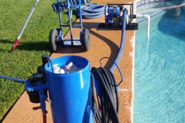 image of swimming pool cleaning equipment placed next to a pool